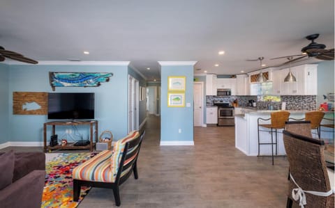 Living room & Kitchen.  Hallway leads to 3 bedrooms and 3 bathrooms.