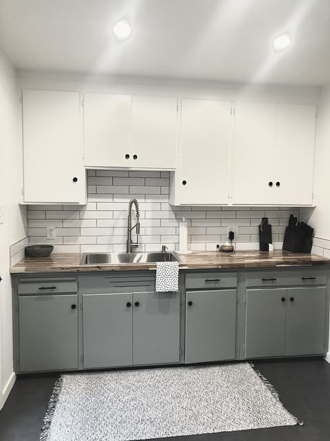 Remodeled kitchen. Brand new floors, sink, counters, backslash, lighting, paint