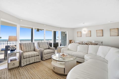 Relax in your bright living room with stunning ocean views through floor-to-ceiling windows and step onto your private balcony.