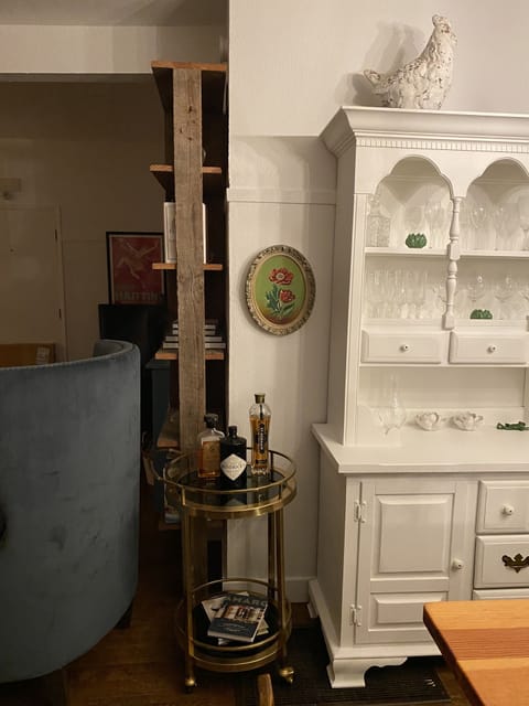 Hutch complete with wine glasses, table linens.