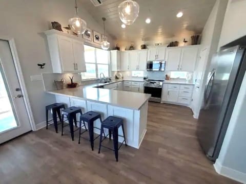 Wide view of the kitchen with all new stainless appliances and convection oven