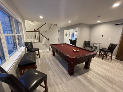 Pool table room with Roku TV and bathroom