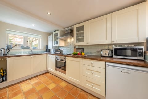 Ground floor: Kitchen with electric cooker, microwave, slimline dishwasher, fridge-freezer and washer-dryer