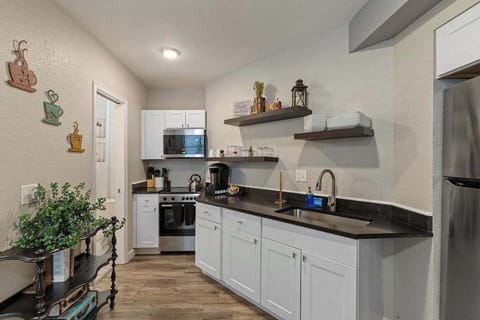 The small kitchen has a full sized stove and microwave.