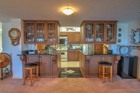 There is a Mini Fridge, Hidden Bar and Bar Height Counters in the Kitchen
