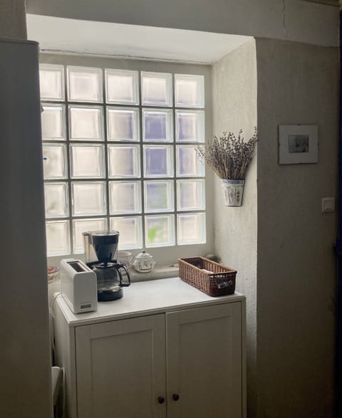 one of the kitchen windows, showing coffee maker and toaster.