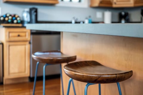 Kitchen island features two barstools.