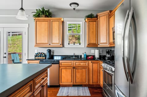 Well stocked kitchen with expanded concrete kitchen island.