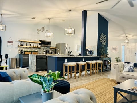 Open floor plan & counter seating allowing conversation w those preparing a meal