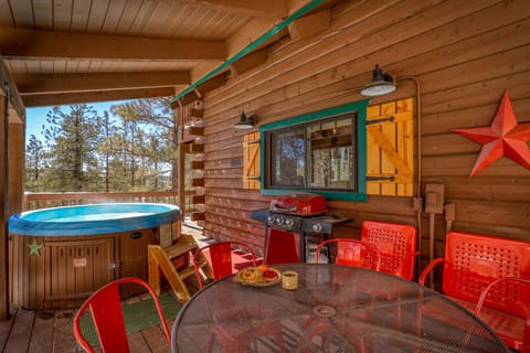 Covered Hot Tub and Outdoor Deck with Seating and Grill