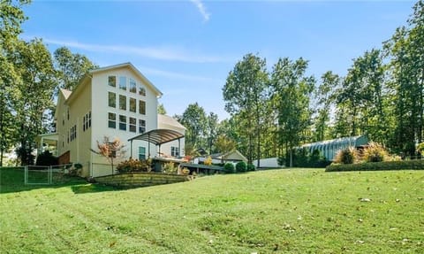 Backyard (fenced) with view of swim spa canopy