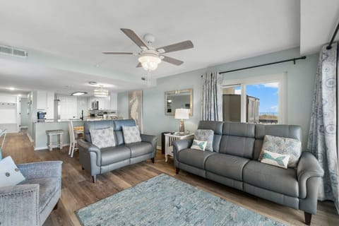 Living room with leather reclining sofa and loveseat.