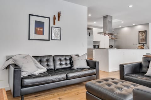 Sink into luxurious leather seating in this open-concept space where your living and kitchen areas flow seamlessly together.