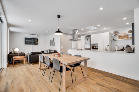 Gather around this beautiful open-plan space where your modern kitchen flows seamlessly into the dining and living areas, perfect for memorable meals together.