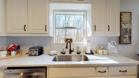 full stocked renovated kitchen with Keurig and plenty of dishes, pots pans 