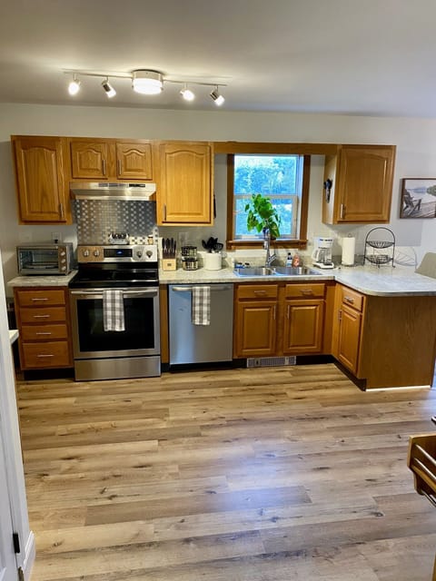 kitchen features stainless steel refirgerator, washer machine, and stove.