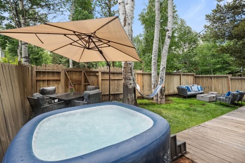 Fenced private yard with hot tub, BBQ, dining and lounging