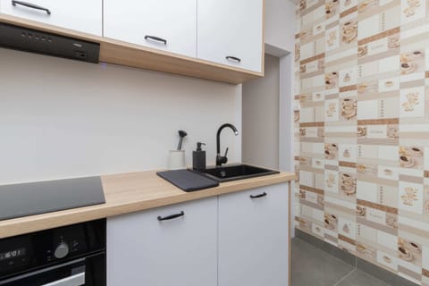 A wider view of the kitchen, showcasing the ample storage space.