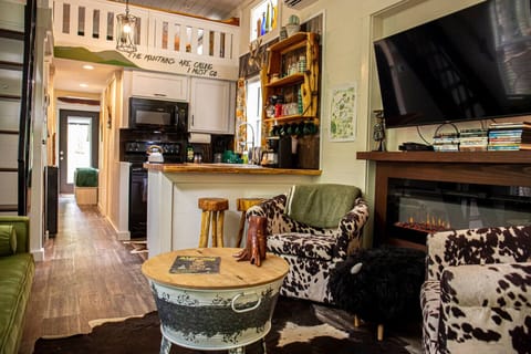 Bright and cozy living room stocked with games (monopoly, monopoly deal, Yahtzee, uno, and cards) and TV with lots of DVDs for all ages as well as free access to YouTube TV.