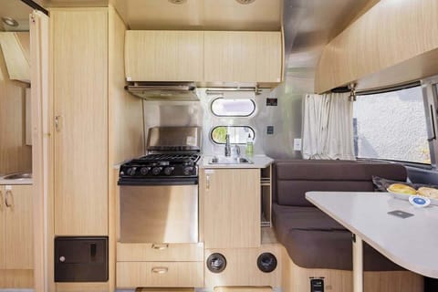 The kitchenette accessories with a sink, stove and storage.