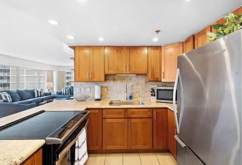 Fully equipped kitchen space with appliances and cabinets for food storage
