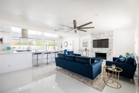 Gather with loved ones in the bright, spacious living room, where the sleek, modern design blends seamlessly with the outdoor view, creating the ideal place to relax and entertain.