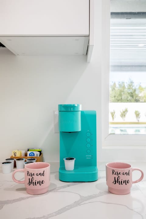 Wake up to the aroma of freshly brewed coffee as morning light fills the kitchen. Enjoy complimentary coffee and tea with K-Cups, sugar, and creamers, brewed in the turquoise Keurig and served in charming “Rise and Shine” mugs for a cozy start to your day.