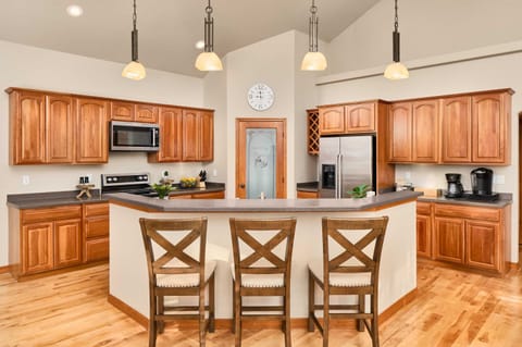 Kitchen with island, microwave, oven, fridge, coffee station, pantry (upstairs)