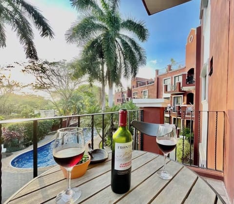 Enjoy a glass of wine on the terrace surrounded by palm trees and nature sounds.