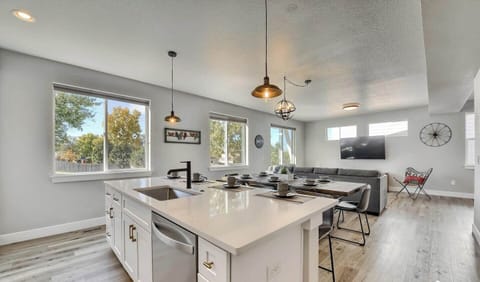 - Central island connects seamlessly to the dining and living areas for easy entertaining
- Multiple windows and clean finishes keep the space light, airy, and welcoming
- Ideal for prepping meals while staying connected to the group