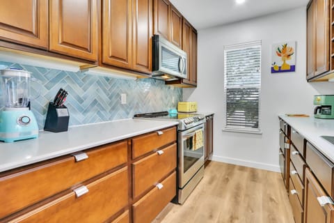 View of range with oven and microwave.