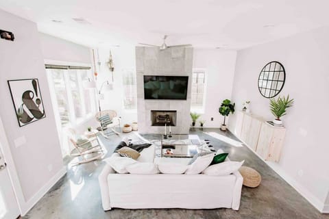 Cozy living room with a Smart TV, Queen sleep sofa, lots of natural light, custom blinds, direct access to the private fenced in yard, and plenty of seating.