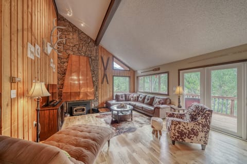 Large open-concept living room with fireplace and TV with streaming capabilities.