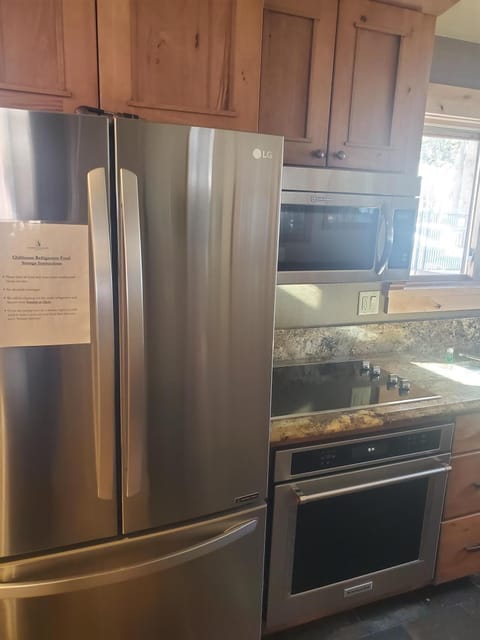 Picture of shared kitchen 2 stoves microwave, shared refrigerator and freezer.