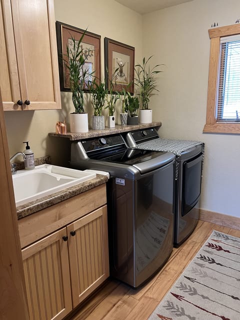 Laundry room with new washer and dryer.
