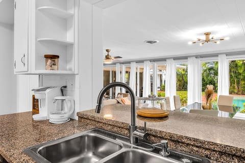 The kitchen has a unique antique feel with the original cabinetry. Upgraded with new flooring and black granite countertops. Fully equipped with everything you need to create a lovely meal for friends and family.