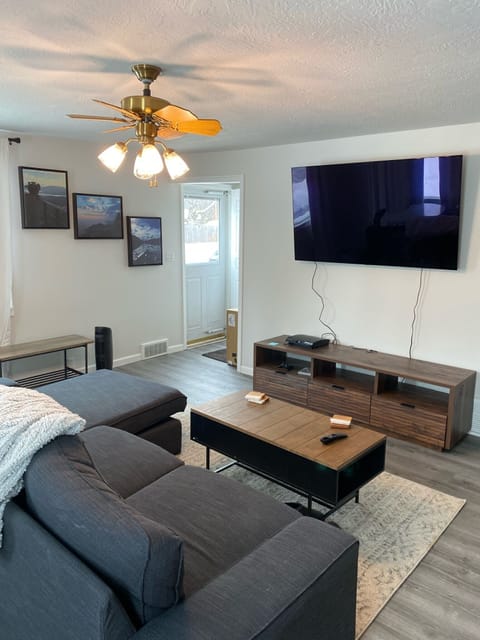 Family/living room with large smart TV and PS3. Couch comfortably seats 4 adults
