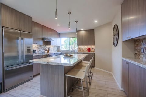 Large upgraded kitchen with bar seating for three people.