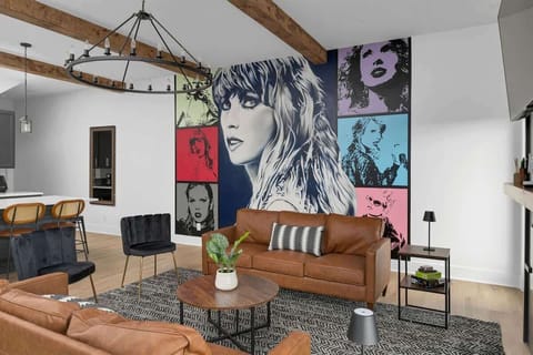 Add some pop to your stay with a Taylor Swift mural in a warm, earthy lounge.