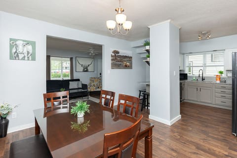 Dining area & kitchen. Table seating for 6 people, with 3 more at the bar