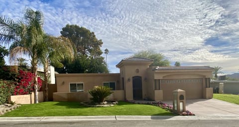 Manicured landscaped front lawn with a Tuscany designed entry gated tower.