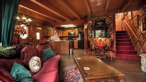 View of living room, dining table and kitchen
