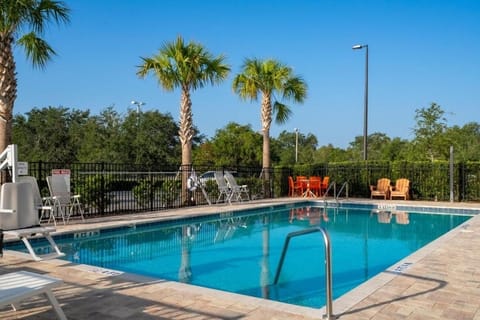 Soak up sunshine beside the sparkling palm-lined pool.
