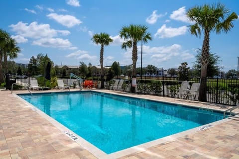 Relax poolside under blue skies and swaying palms.