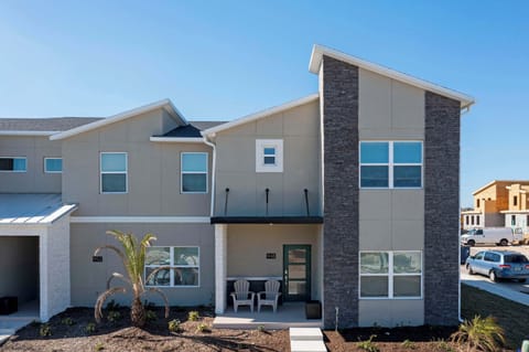 Modern front exterior with stylish stone accents, a welcoming porch, and crisp curb appeal-an inviting first look at your stay!