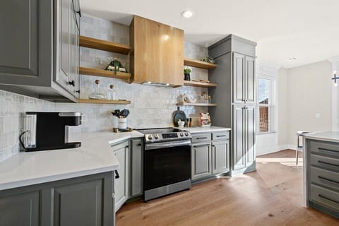 Our kitchen is outfitted with a beautiful white tile backsplash, white countertops and natural wood accents!