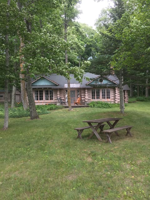 front of the cabin, facing the lake