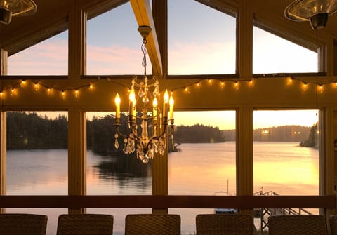 Enjoy the sunset on the covered deck under a chandelier.