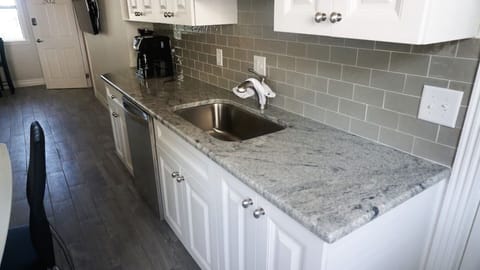 Kitchen opens onto quiet picnic and grill area, with banana trees and bike racks