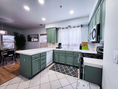 Newly painted kitchen cabinets and walls with many appliances, like air fryer!